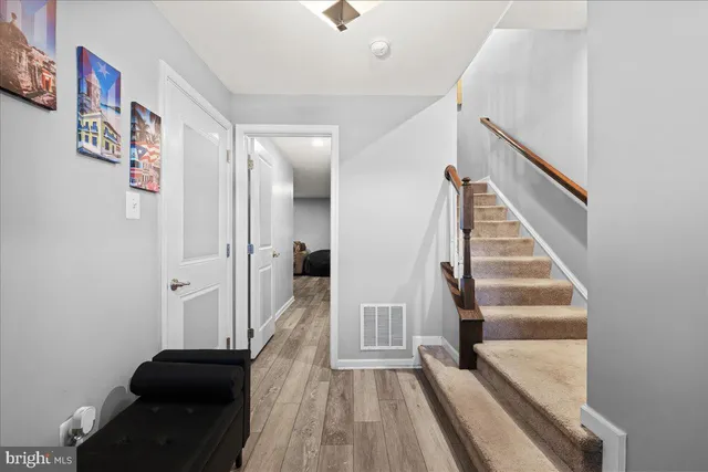 a view of front door with hallway and stairs