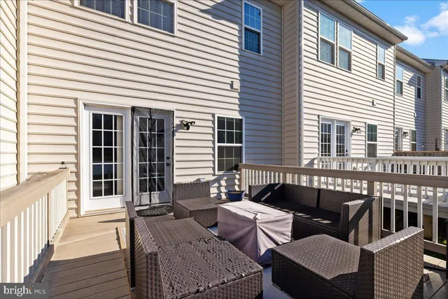 a balcony with furniture and wooden floor