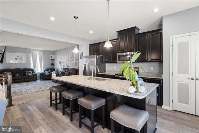 a dining room with furniture and wooden floor