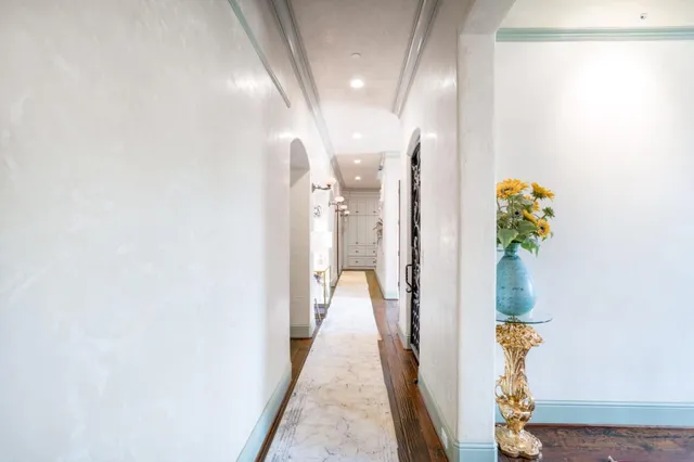 a view of hallway with wooden floor