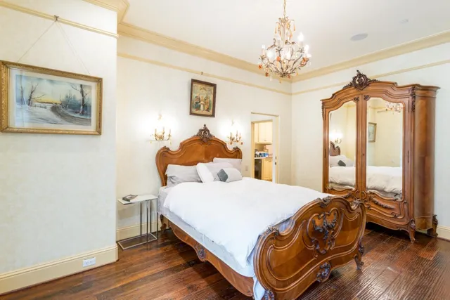 a bedroom with a bed and a chandelier