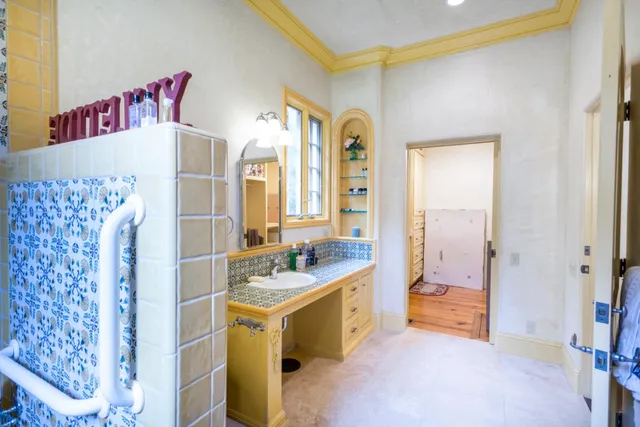 a bathroom with a sink a mirror and a shower