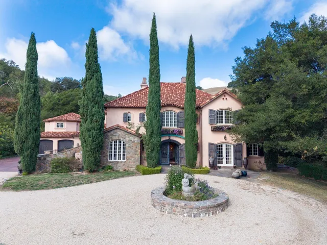a front view of a house with a garden and plants