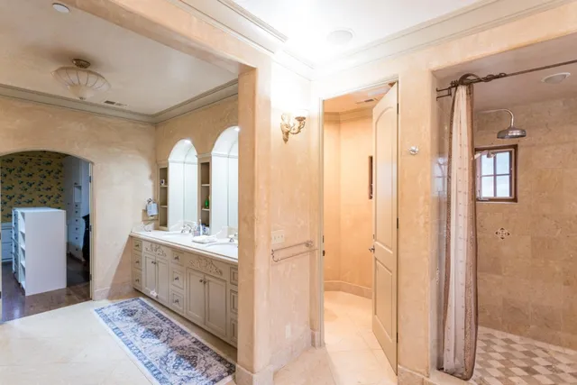 a bathroom with a double vanity sink and mirror with shower