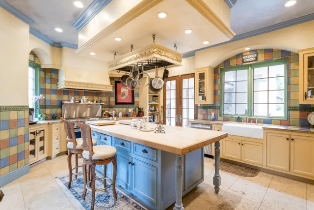 a large kitchen with a table and chairs