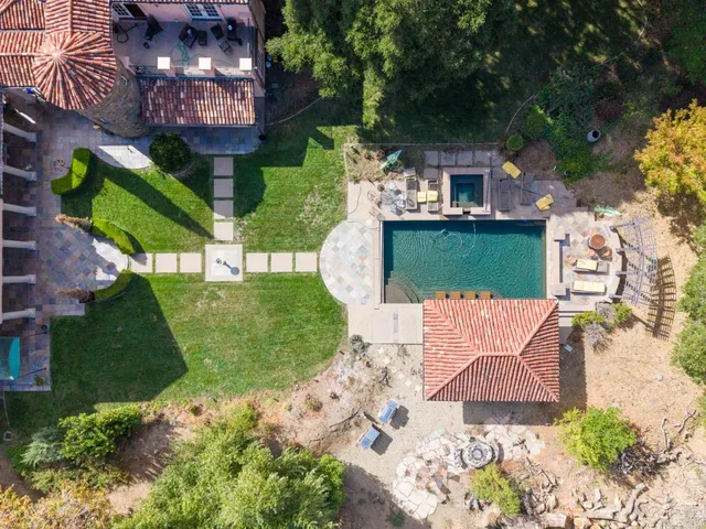 an aerial view of a house with garden space and street view