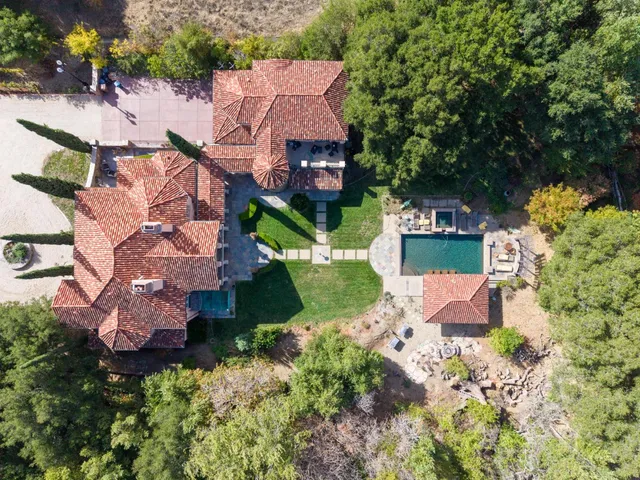 an aerial view of multiple houses with yard