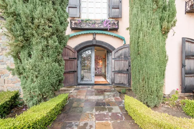 a front view of a house with a garden
