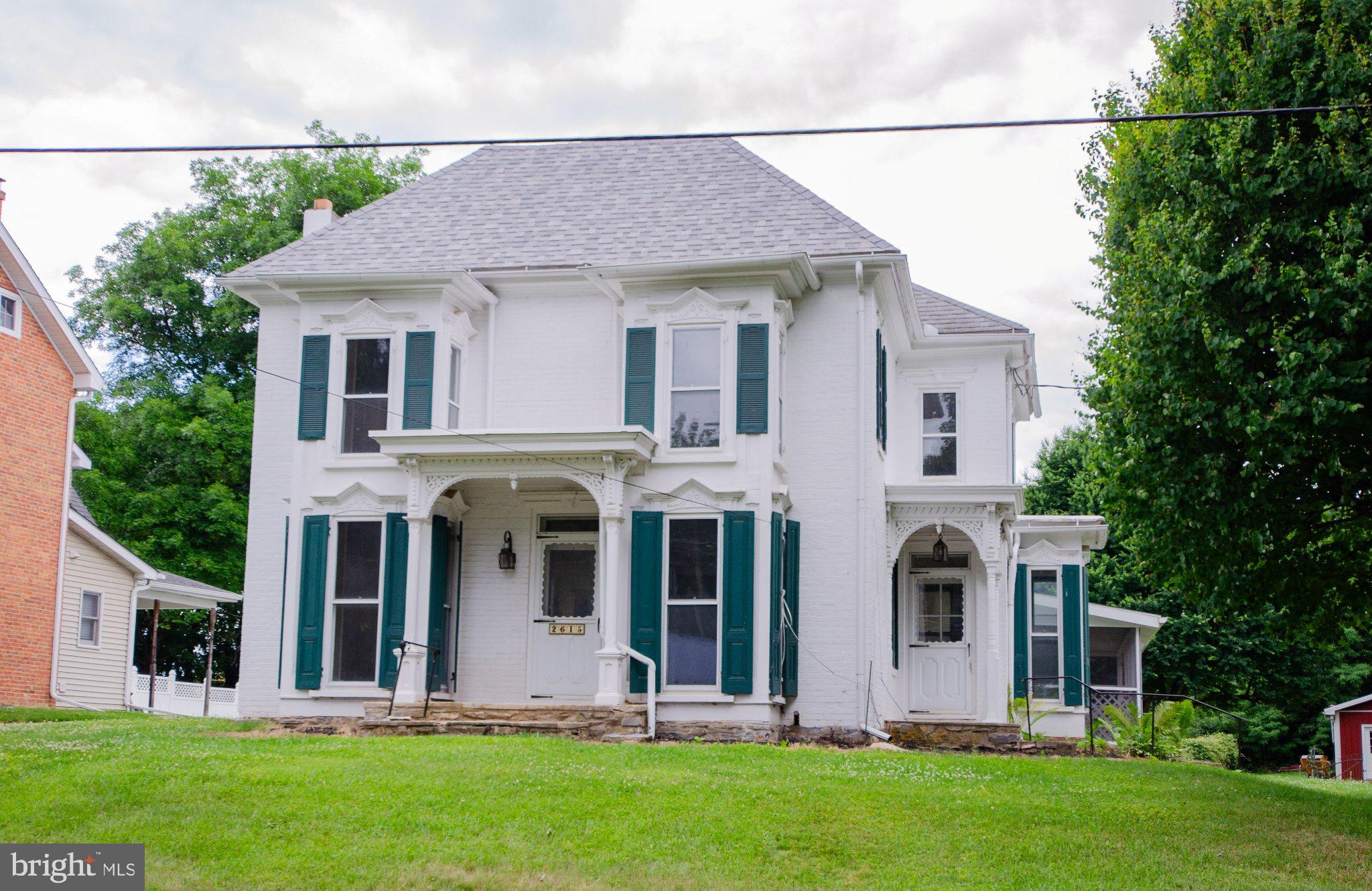 Charming Victorian with lush surroundings.