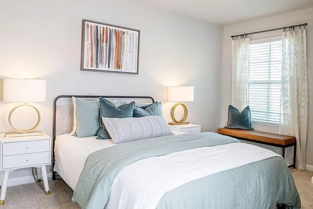 a bedroom with bed and wooden floor