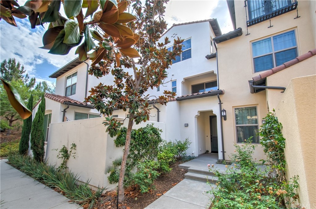 89 Tallowood Irvine, CA 92620 - Photo 1 of 1 front view of a house with a tree