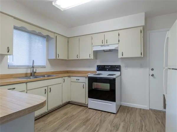 a kitchen with stainless steel appliances white cabinets and a sink