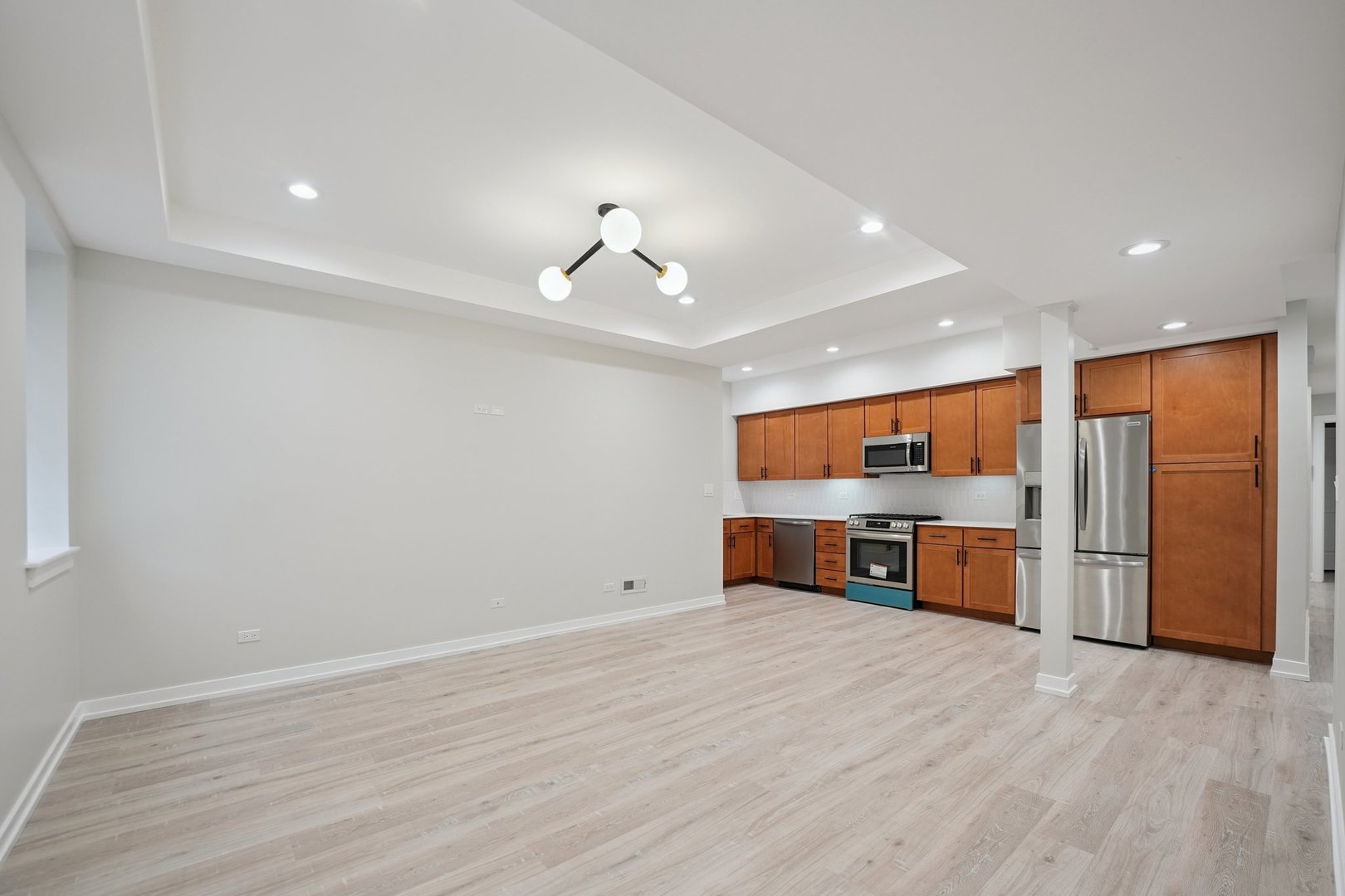 1635 West Warren Boulevard, Unit 1 Chicago, IL 60612 - Photo 3 of 14 a view of kitchen with stainless steel appliances refrigerator and microwave