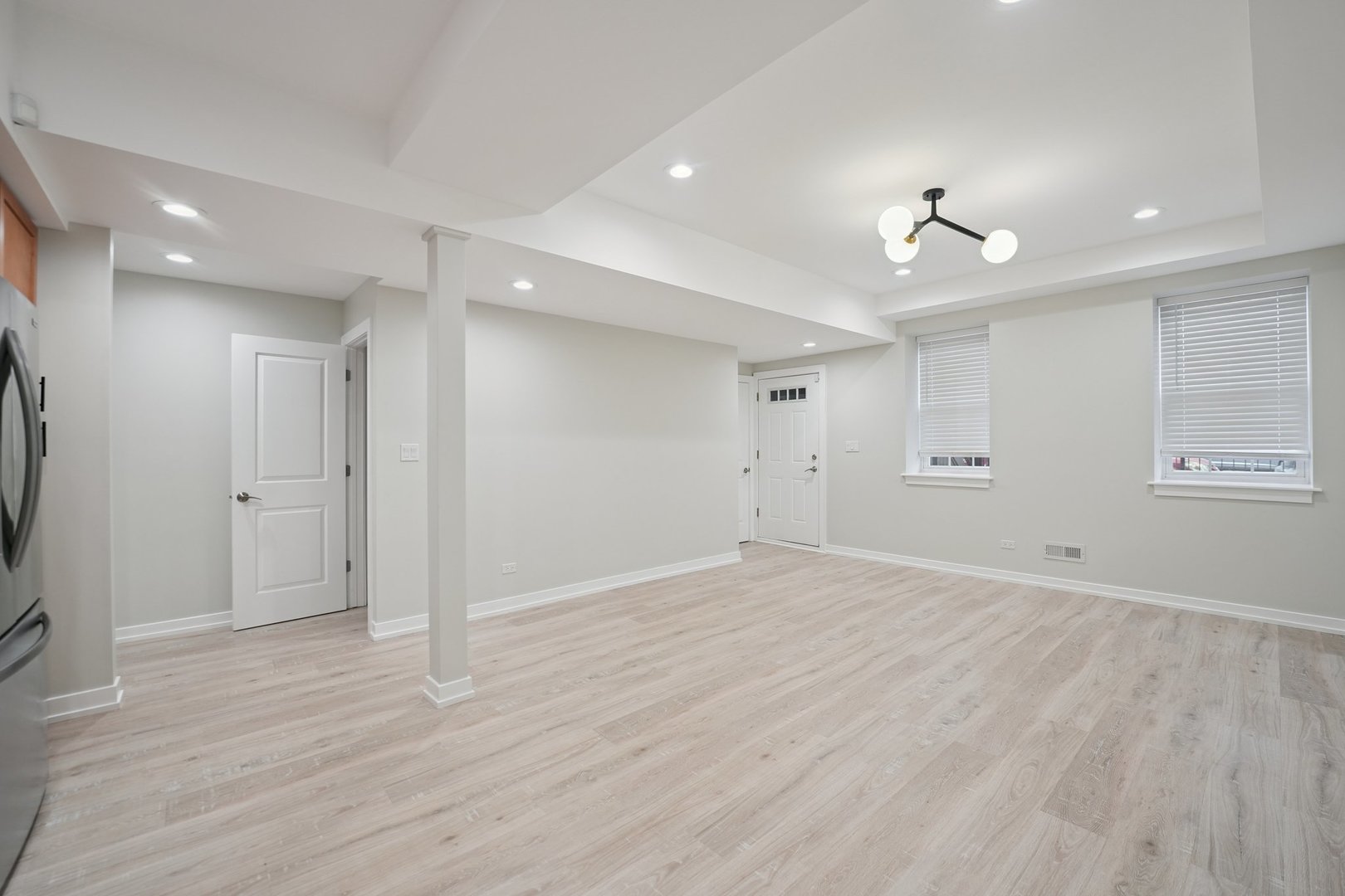 1635 West Warren Boulevard, Unit 1 Chicago, IL 60612 - Photo 7 of 14 a view of empty room with wooden floor and fan