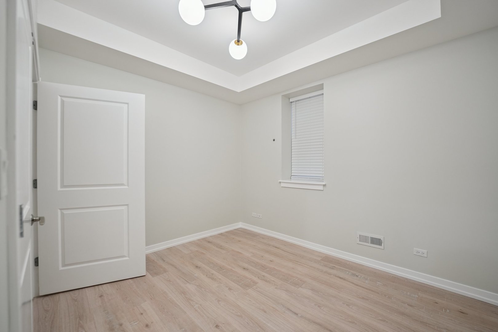 1635 West Warren Boulevard, Unit 1 Chicago, IL 60612 - Photo 8 of 14 a view of empty room with wooden floor and ceiling fan
