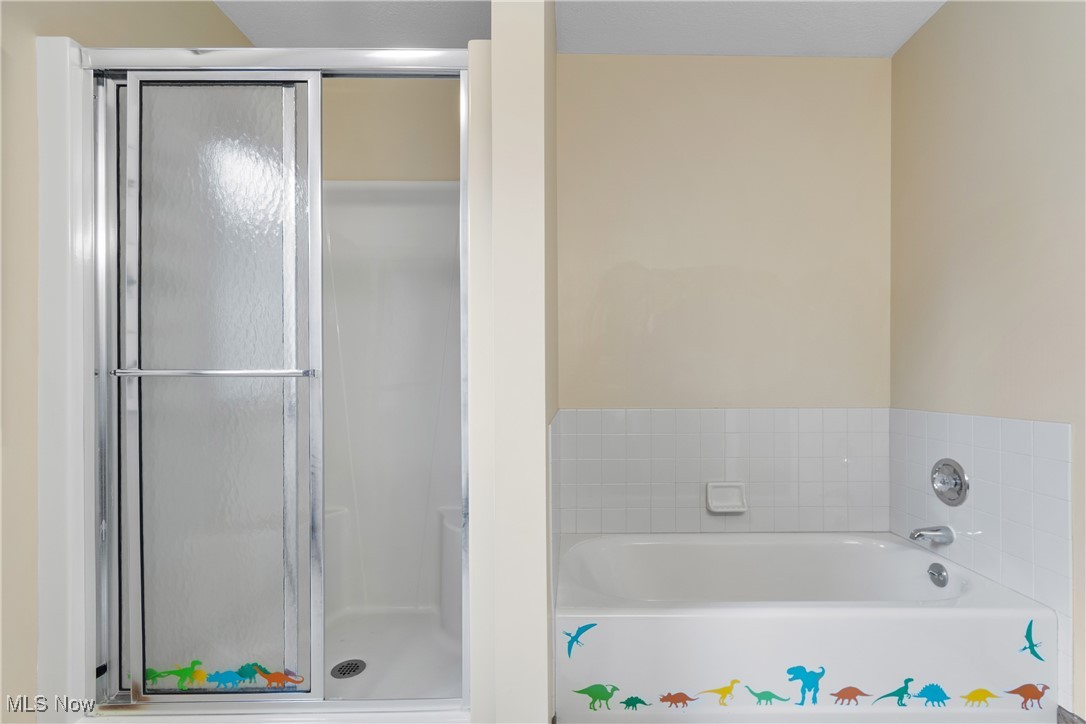 2317 Raintree Street Northeast Canton, OH 44705 - Photo 23 of 40 Bathroom featuring a shower stall and a garden tub