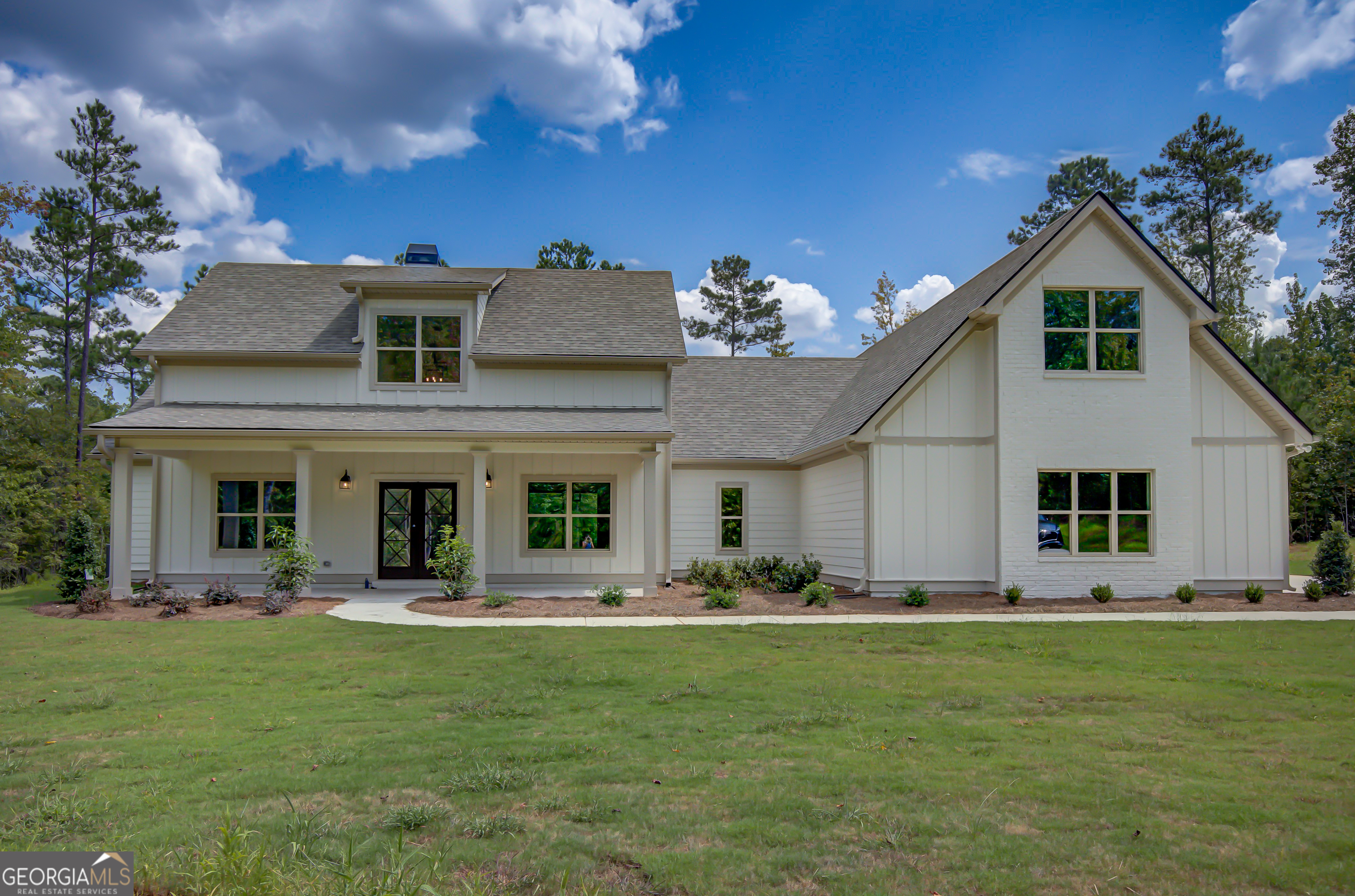 a front view of house with yard and outdoor seating