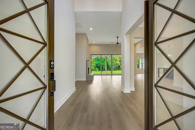 a kitchen with a sink a window and wooden floor