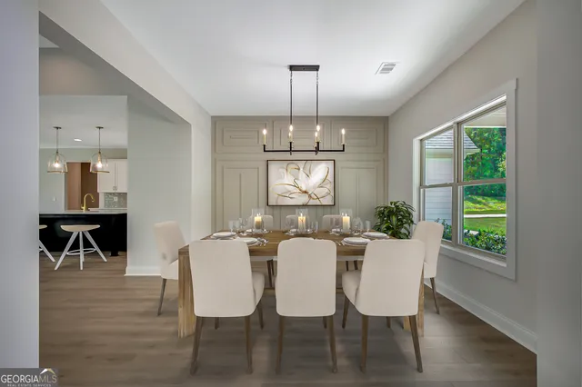 a view of a hallway with wooden floor and entryway