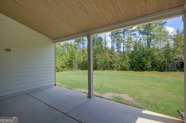 a large kitchen with granite countertop a stove top oven a sink dishwasher and a fireplace with wooden floor
