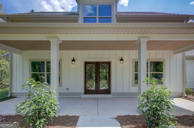 a view of an empty room with wooden floor fireplace and a window