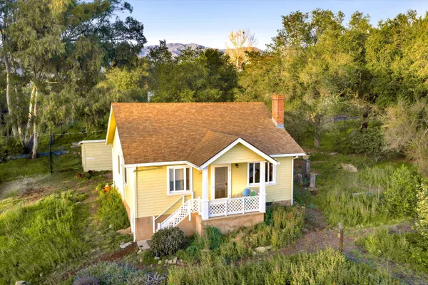 a aerial view of a house with a yard
