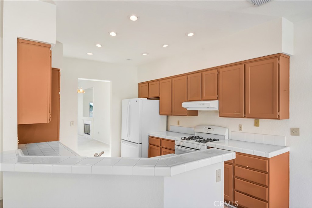 69860 Mccallum Way Cathedral City, CA 92234 - Photo 11 of 25 a kitchen with a refrigerator and a sink