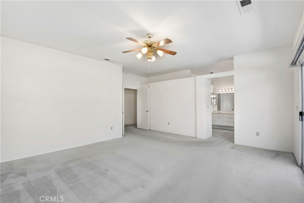 69860 Mccallum Way Cathedral City, CA 92234 - Photo 15 of 25 an empty room with closet and a chandelier fan