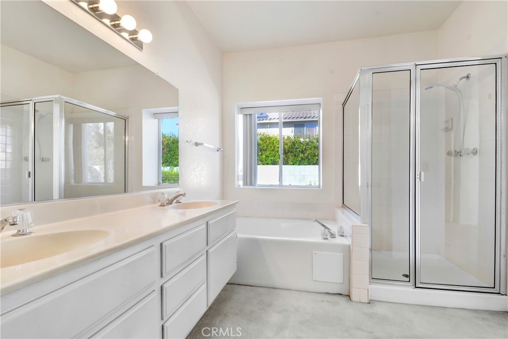 69860 Mccallum Way Cathedral City, CA 92234 - Photo 16 of 25 a bathroom with a bathtub a sink and a window