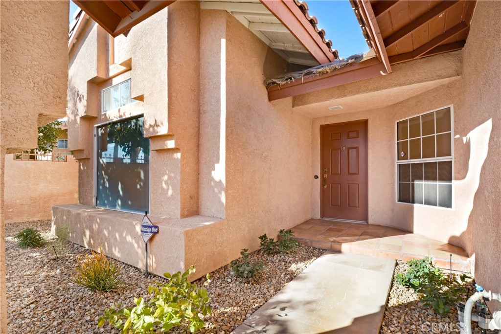 69860 Mccallum Way Cathedral City, CA 92234 - Photo 3 of 25 a front view of a house with a yard