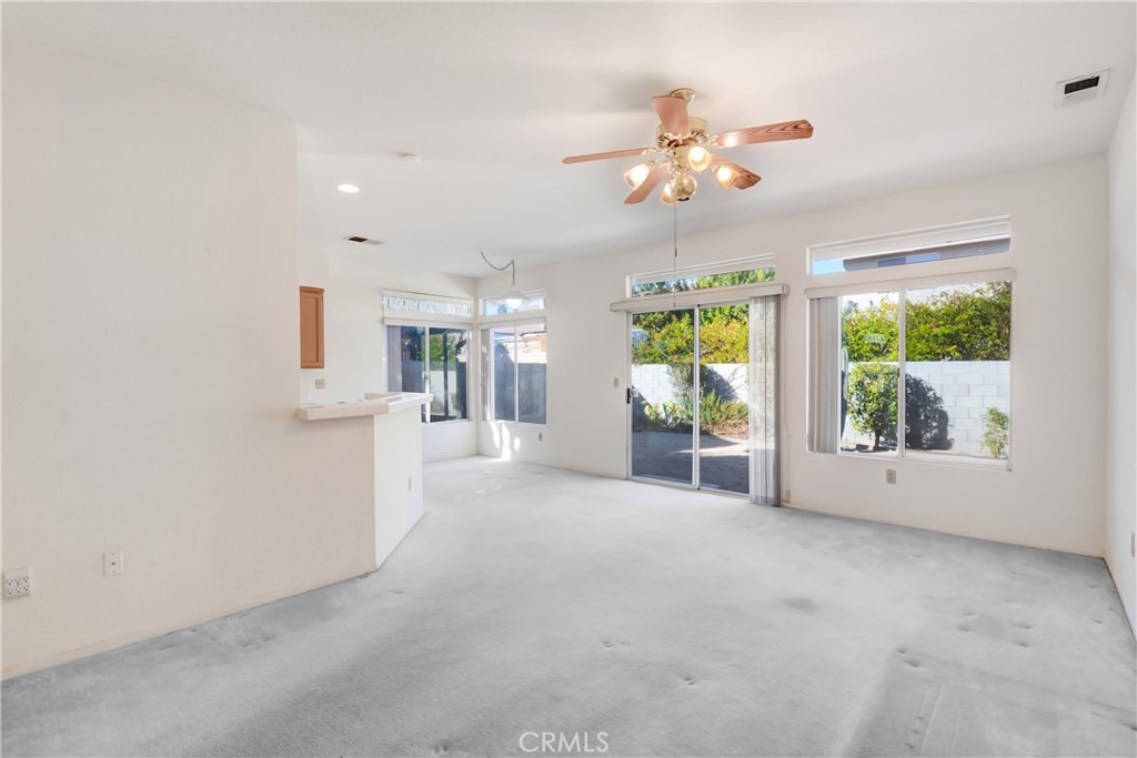 69860 Mccallum Way Cathedral City, CA 92234 - Photo 8 of 25 a view of a livingroom with a ceiling fan and window
