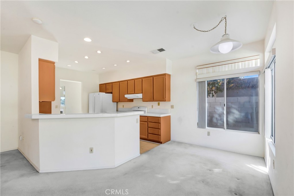 69860 Mccallum Way Cathedral City, CA 92234 - Photo 9 of 25 a view of cabinets a sink and a stove top oven