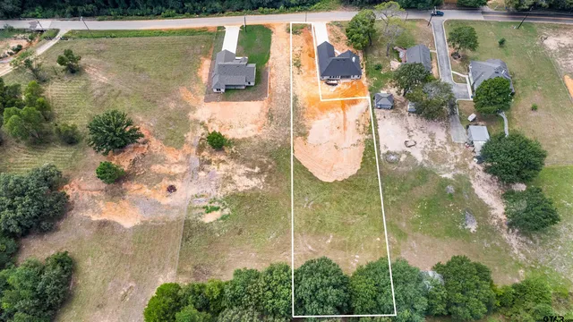 an aerial view of residential house with pool and garden