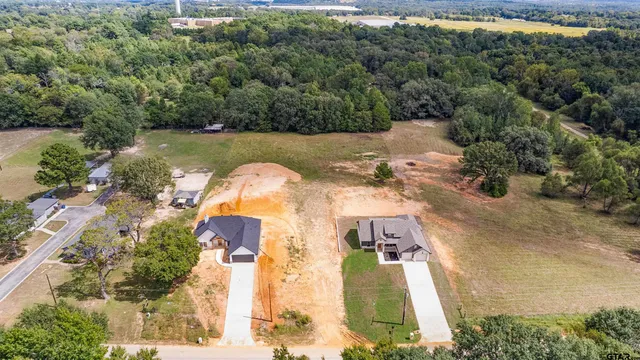 an aerial view of a house with outdoor space and swimming pool