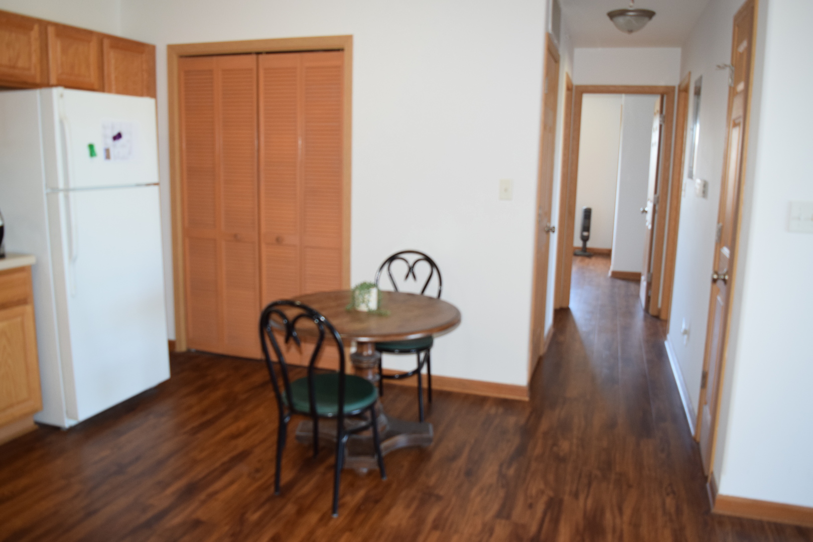 565 North Strack Street, Unit 302 Cortland, IL 60112 - Photo 7 of 15 a view of a dining room with furniture and wooden floor