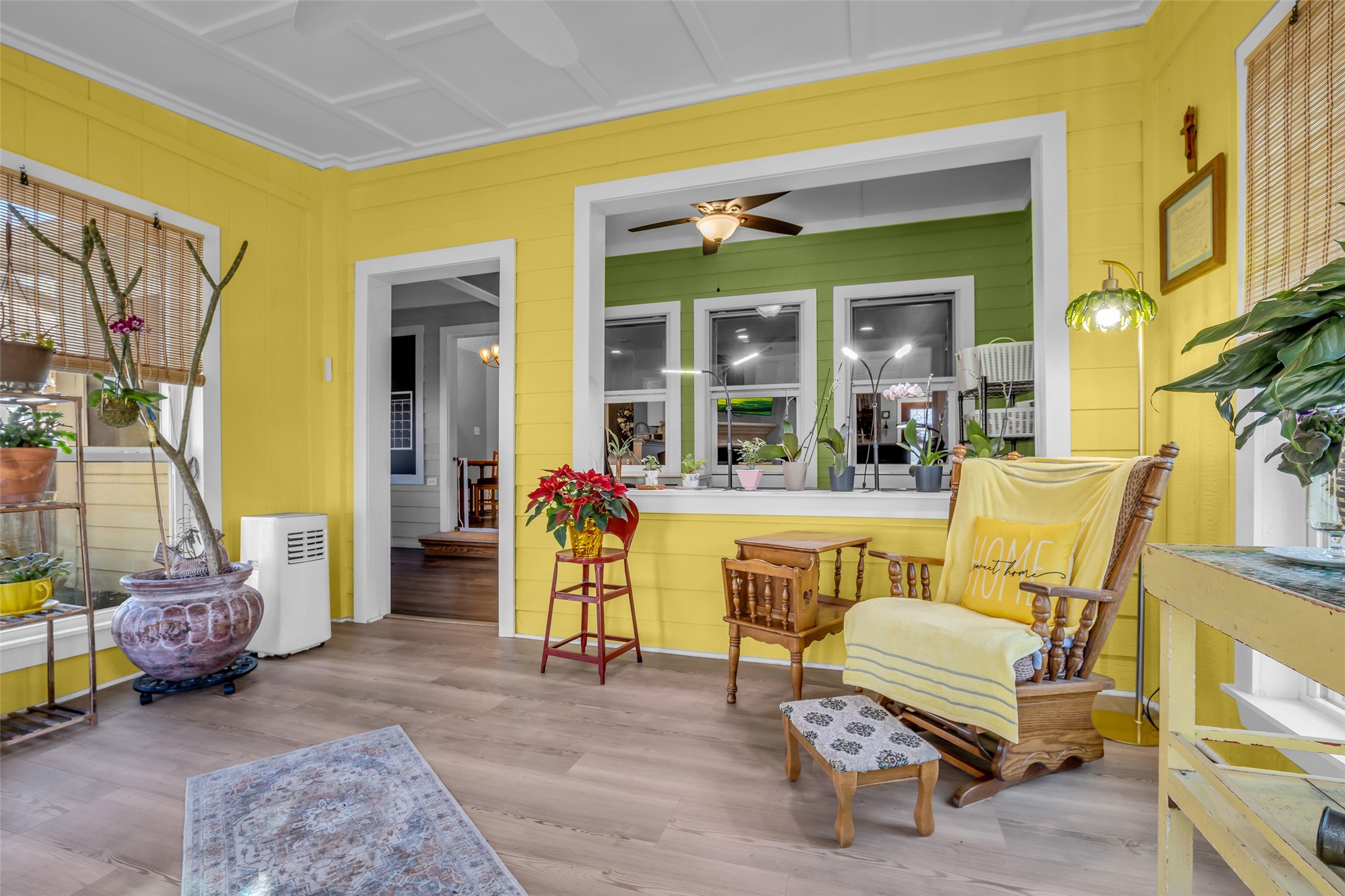 242 Sunset Path North Conroe, TX 77316 - Photo 17 of 37 Welcome to your Four Seasons Sunroom! Windows, charming architectural trim feature at ceiling follows the style of the open bookcases in the living area. 242 SUNSET PATH N - Request your tour today!