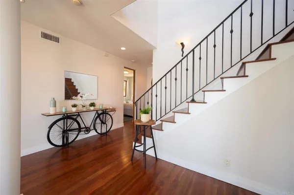 a view of entryway with wooden floor and stairs