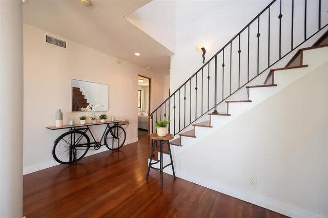 a view of entryway with wooden floor and stairs