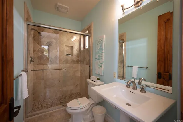 a bathroom with a sink toilet and shower