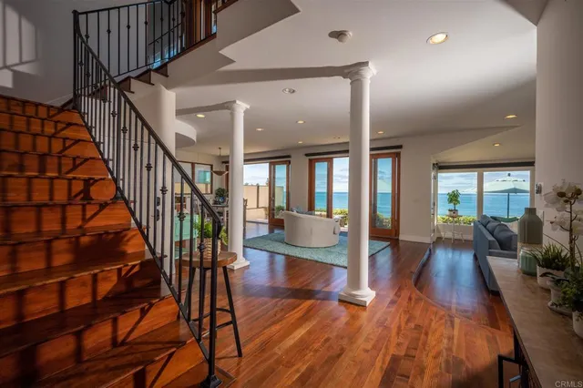 a view of a living room and workspace with wooden floor