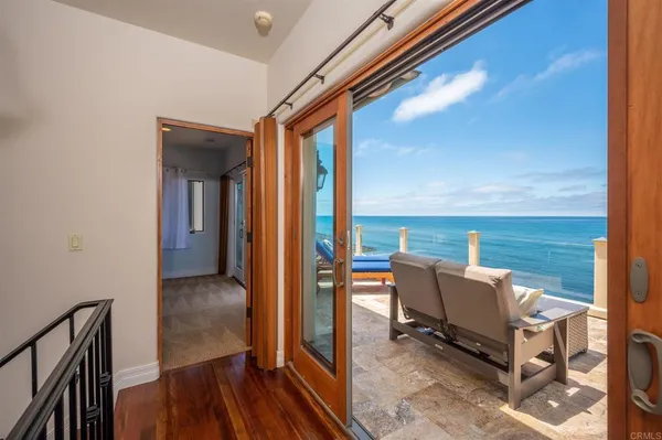a balcony with chairs and wooden floor
