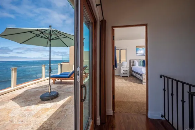 a view of a hallway with a dining room and stairs