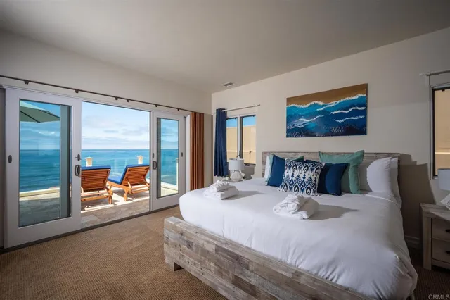 a bedroom with a large bed and a large window