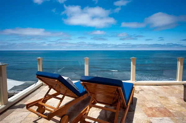 a view of yard from deck with patio