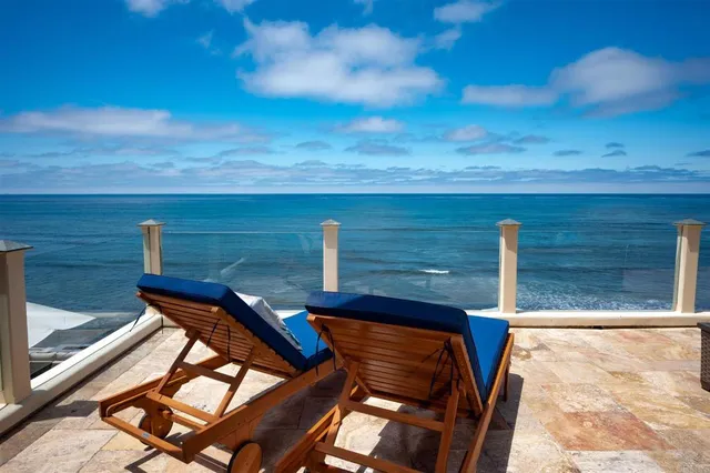 a view of yard from deck with patio