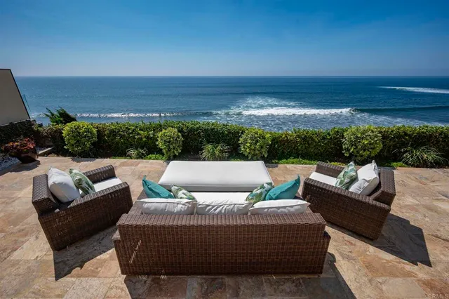 a view of a patio with couches and potted plants