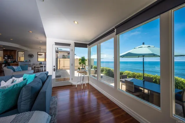 a living room with furniture and a floor to ceiling window