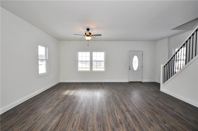 61 Bethel Ridge Road Avella, PA 15312 - Photo 13 of 28 an empty room with wooden floor chandelier fan and windows