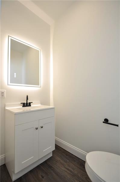 61 Bethel Ridge Road Avella, PA 15312 - Photo 15 of 28 a bathroom with a toilet a sink a vanity and mirror