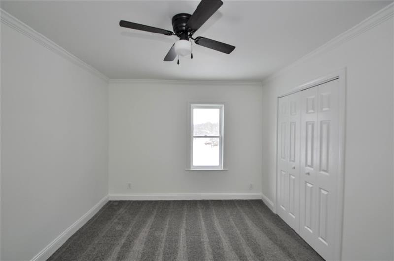 61 Bethel Ridge Road Avella, PA 15312 - Photo 22 of 28 an empty room with a window and a ceiling fan